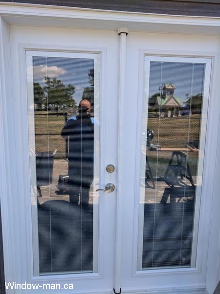 Patio French doors with blinds. Inswing. White. Tilt and lift internal Mini Blinds. Installed